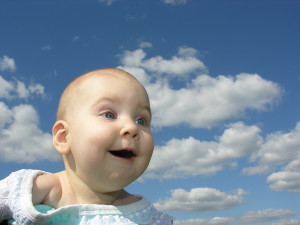 bigstockphoto_Happy_Baby_Under_Clouds_153604
