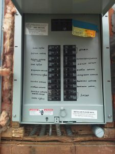 electrical panel with circuit breakers visible