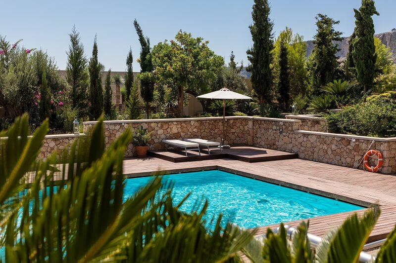 swimming pool in backyard with a lot of trees around