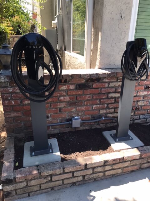 Install two Tesla Wall Connectors on pedestals