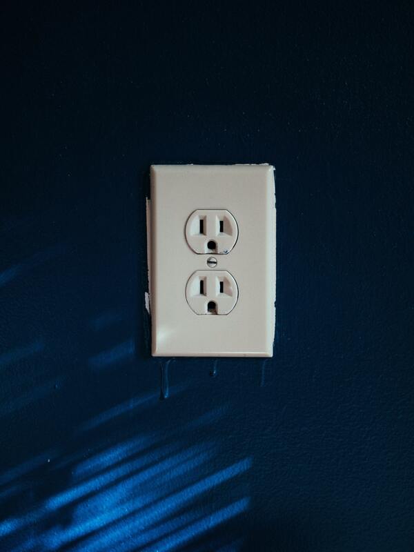 white electrical outlet on blue wall