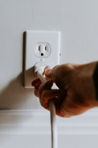 hand plugging appliance into outlet