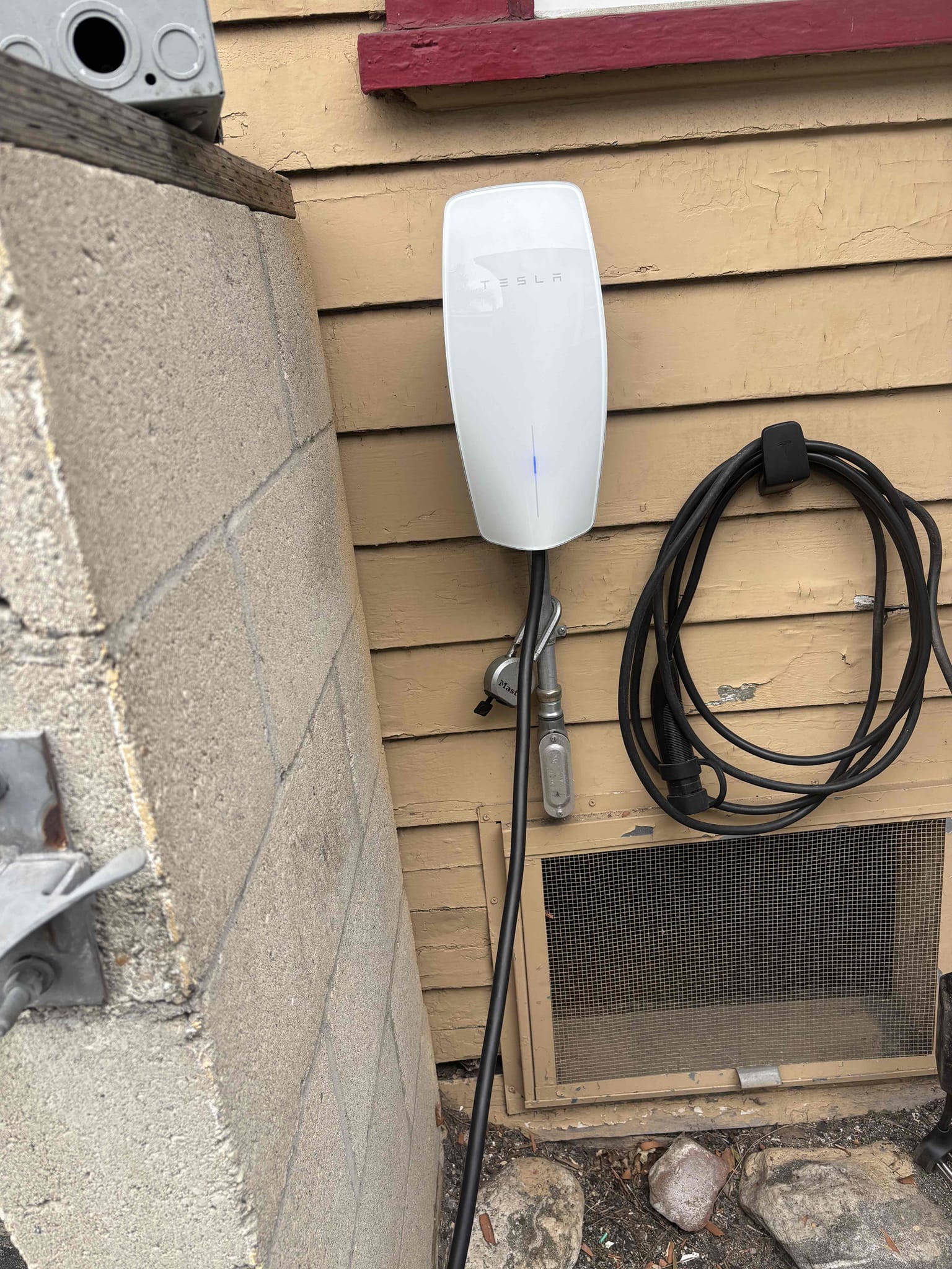 Harwired Tesla Wall Connector installed outside