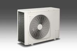A side-profile view of a white rectangular outdoor air conditioning condenser unit featuring a large circular fan grille.